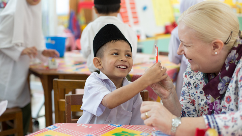 Teacher with young student in Brunei