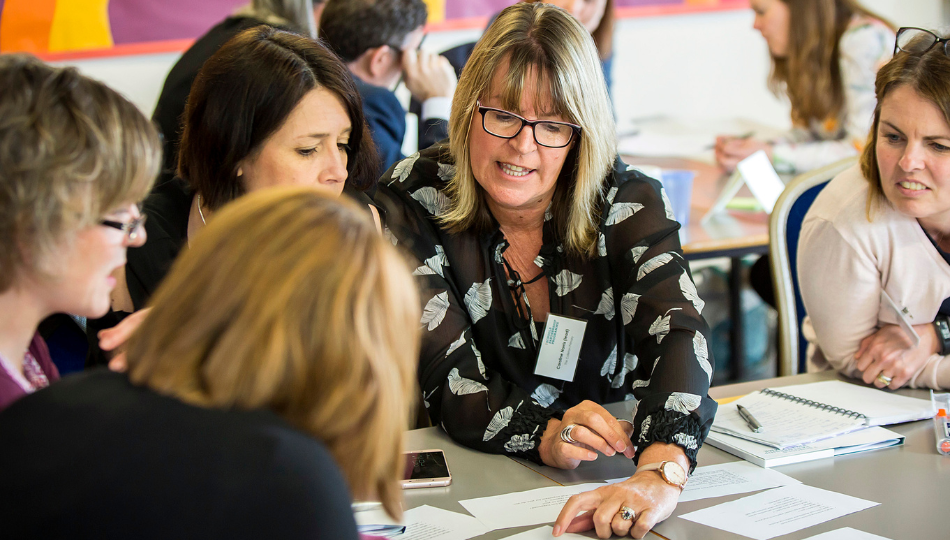 A group of teachers collaborating at a conference